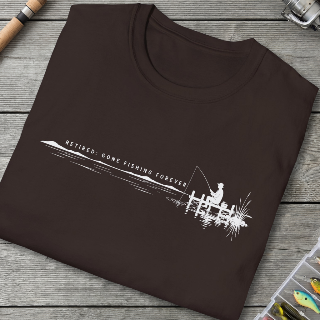Brown t-shirt with fishing graphic and text on a wooden surface