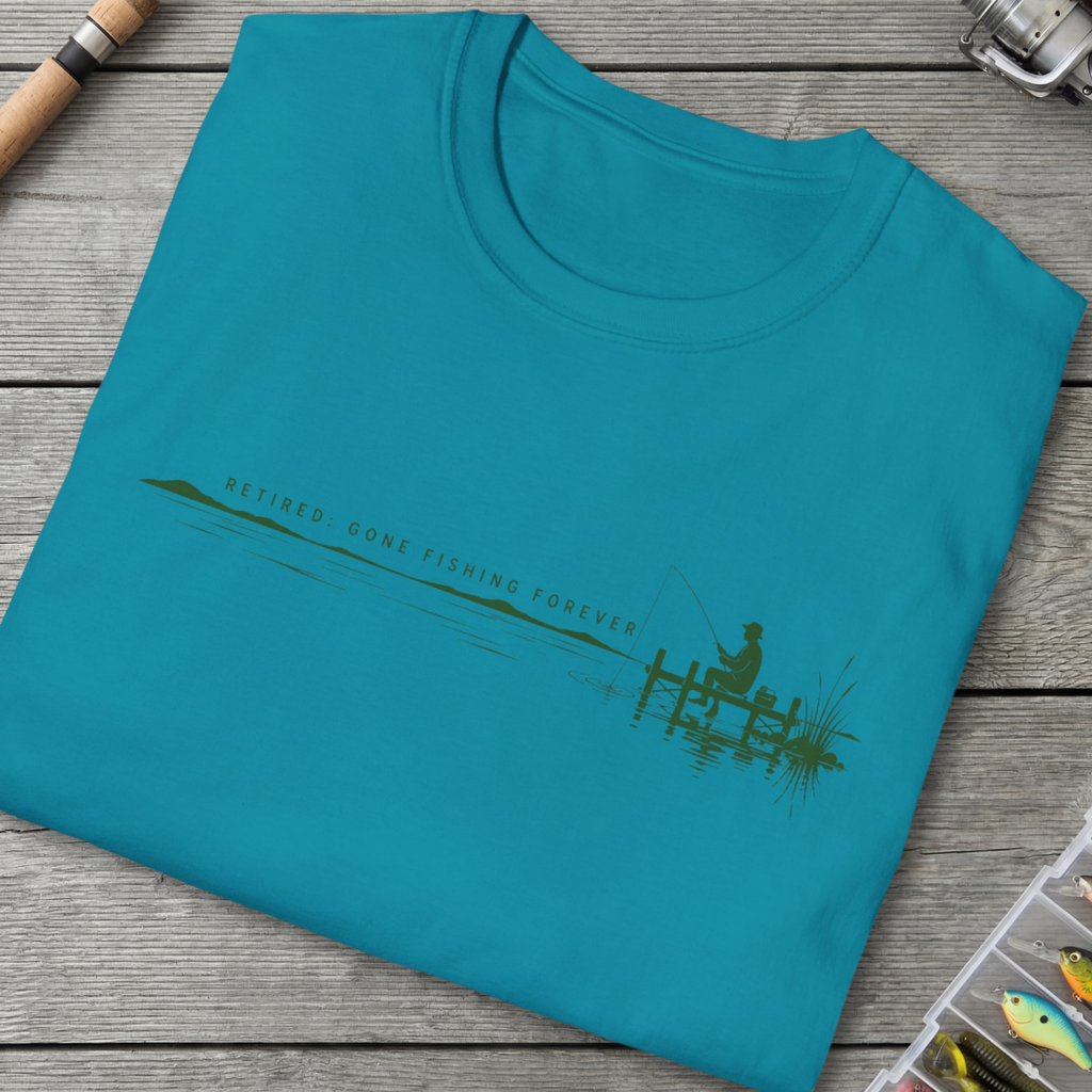 Blue t-shirt with fishing graphic and text on a wooden surface